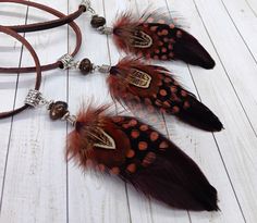 Real Feather Necklace Choker/ Western Jewelry / Southwestern Necklace  Welcome to Sun Sea Studio. These are Southwestern Style Real Feather Necklace/Chokers. Created with colorful brown shades of feathers, these necklace/chokers have a silver carved bale with a bronzite bead drop. This is on a 34 inch piece of real leather that can tie in a bow around your neck. Try tying it in your hair or around your head!   Ready to ship!         All Sun Sea Studio designs are created with an eye for detail, gorgeous color and visual balance.           If you would like to see more Unique Artisan Sun & Sea Western Jewelry, Apparel and Accessories, here is the link to my shop http://www.etsy.com/shop/SunSeaStudio FB: http://www.facebook.com/SunSeaStudios IG: https://www.instagram.com/Sun_sea_stacy Western Tote Bags, Visual Balance, Sea Turtle Jewelry, Rodeo Jewelry, Western Necklace, Southwestern Necklace, Jewelry Western, Western Necklaces, Turtle Jewelry