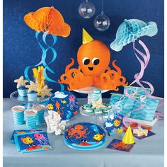 an octopus themed birthday party with blue and orange decorations, under the sea theme paper plates and napkins