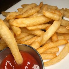 french fries and ketchup on a white plate