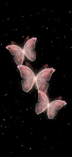 three pink butterflies flying through the air with stars in the sky behind them on a black background