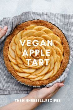 vegan apple tart in a pie pan with the words vegan apple tart above it