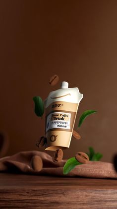 a bottle of coffee on top of a wooden table next to some leaves and nuts