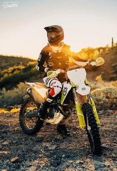 a man riding on the back of a dirt bike