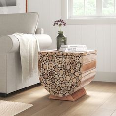 a living room with a couch, chair and table made out of tree trunks on the floor