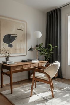 a desk with a chair, lamp and pictures on the wall in front of it