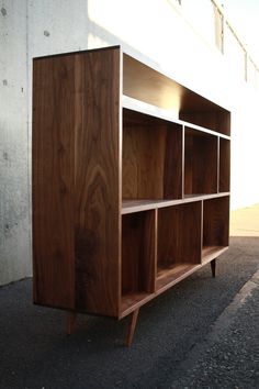 a wooden shelf sitting on the side of a building