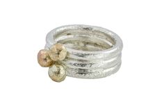 This beautiful silver stacking ring is one solid ring, the three rings have been soldered together.  Two of the rings have a 9ct yellow gold ball & one of them has a 9ct rose gold ball. The rings have been soldered together to form a cluster. Its a fairly chunky ring with its delicately textured silver band and contemporary mixed metal design, you can easily wear this ring everyday. The width of the ring is 0.8mm wide & the gold balls are about 0.4mm round. This ring will arrive in a cream box, ready for gift giving. Handmade Rose Gold Sterling Silver Stackable Rings, Handmade Sterling Silver Stackable Rings In Rose Gold, Unique Hammered Stackable Rings For Promise, Pebble Ring, Chunky Ring, Minimalist Studs, Three Rings, Etsy Gold Ring, Silver Stacking Rings