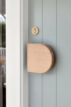 a wooden door handle on the side of a house