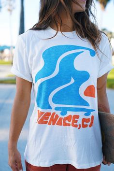 Our hometown - Venice, CA! Flowy skater design mixed and bright colors embodies Venice essence! The tee is the softest, most cozy shirt -- with a vintage wash, it looks like you grabbed it straight from your cool aunts 70s wardrobe. Our limited edition Junk Food Clothing Tee Shirt Collab is here! Now your favorite soft tees come in your favorite GRLSWIRL style. Graphic Tee T-shirt For Skateboarding With Relaxed Fit, Casual Acid Wash T-shirt With Graphic Design, Retro Acid Wash Tops With Graphic Print, Retro Acid Wash Graphic Print Tops, Sporty Acid Wash T-shirt For Summer, Retro Soft-washed White T-shirt, Retro White Soft-washed T-shirt, Casual Cotton Tops With Retro Print, White T-shirt With Screen Print For Skateboarding