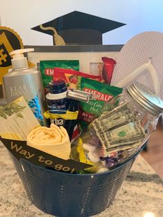 a blue bucket filled with lots of items on top of a marble counter next to a pair of flip flops