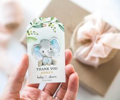 a person holding up a small card with an elephant on it's back and the words, thank you jenny's