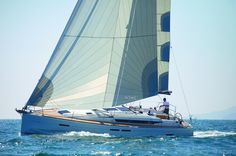 a sailboat sailing in the ocean on a sunny day