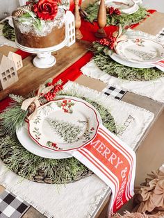 the table is set with plates, napkins and christmas decorations on top of it