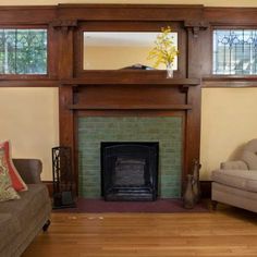 a living room with two couches and a fire place in the middle of it