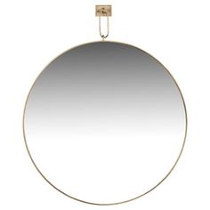 a round mirror hanging on a hook