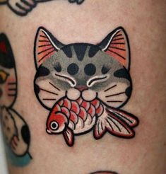 a close up of a cat with a fish on it's leg and other tattoos