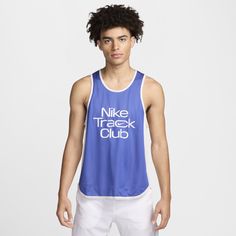 a young man wearing a blue nike track club tank top with white lettering on the front