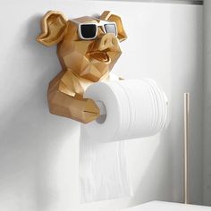 a toilet paper holder with a pig wearing sunglasses on it's head and holding a roll of toilet paper