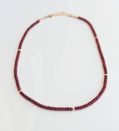 This exquisite handmade Ruby bead necklace boasts the deep, captivating dark pink shade of July's birthstone, with natural Ruby beads carefully selected to create a timeless piece of jewelry. A stunning addition to any bridal outfit or a unique gift for Mom on Mother's Day, this necklace is sure to dazzleA timeless piece, a gift from the heart, a treasure to cherish.T H E ∙ S M A L L ∙ D E T A I L S• Natural Ruby 3mm faceted rondelle beads• Length of necklace: 18 inches + 2 inch 14k Gold filled Single Strand Ruby Bead Necklace, Elegant Ruby Necklace With Polished Beads, Ruby Single Strand Beaded Necklaces With Round Beads, Single Strand Ruby Beaded Necklaces With Round Beads, Single Strand Ruby Beaded Necklace With Round Beads, Burgundy Beaded Necklaces With Round Beads As Gift, Elegant Burgundy Beaded Necklaces With Round Beads, Red Single Strand Necklace For Wedding, Red Garnet Beaded Necklaces With Round Beads