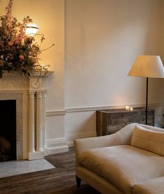 a living room filled with furniture and a fire place