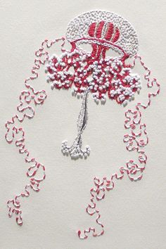 a red and white piece of art made out of beads