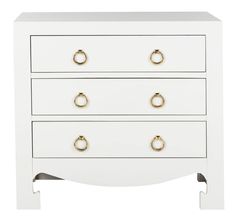 a white chest of drawers with gold handles and knobs on the bottom, against a white background