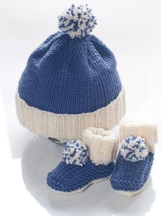 a knitted hat, booties and mittens are sitting next to each other