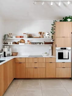 a kitchen with wooden cabinets and white counter tops