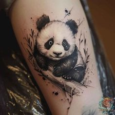 a black and white panda bear tattoo on the leg