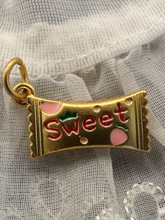 SUPER SWEET CHARM! This cute little charm or pendant would be great for a charm necklace! Fun strawberry candy charm! Both sides designed.  New and unworn. Matte gold tone with enamel. Jump ring included. Please refer to pic with ruler for measurements in inches. Cheap Retro Necklaces With Vintage Charm, Cute Charm Necklaces For Birthday, Cute Pendant Charms For Gifts, Personalized Cute Charms For Birthday, Cute Personalized Birthday Charms, Cute Charms With Lobster Clasp For Gift, Cute Heart-shaped Charm Necklaces, Cute Gold Charms For Gifts, Cute Nickel-free Charms For Gifts