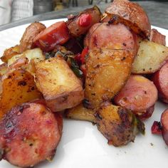 a white plate topped with potatoes and meat