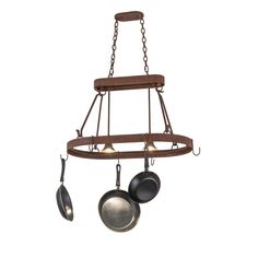 an old fashioned hanging pot rack with pots and pans