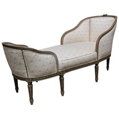 an antique style chaise lounge with white upholstered fabric