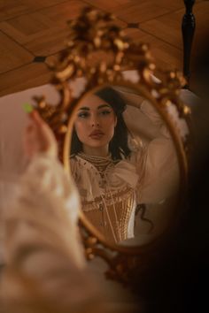 a woman looking at herself in the mirror