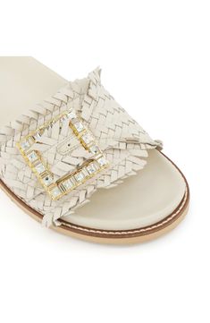 Sparkling crystals highlight the buckle detail of this updated slide sandal topped with a textured leather strap. Leather upper/synthetic lining and sole Imported Luxury Summer Slides With Tang Buckle, Embellished Leather Slip-on Sandals, Luxury Beach Sandals With Tang Buckle, Dune London, Sparkling Crystal, Slide Sandals, Sliders, Warm Weather, Leather Straps