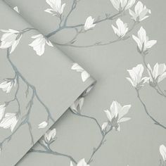 the wallpaper has white flowers on it and is grey with gray trimmings