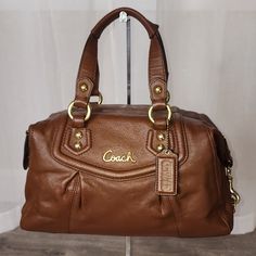 Item : Coach Ashley Leather Convertable Satchel Coach Style 19247 Ashley From 2012 Approximate : 12" X 9 1/4" X 4 1/2" (Handles With 5" Drop And Longer Strap For Shoulder Wear) Material : Authentic Leather Colour : Brass/English Tan Condition : Excellent, Bag Has Been Redyed To Original Color. Only Notable Wear To The Hardware (Mainly On The Feet) See Pictures For Details On Condition Questions? Leave A Comment Below! Coach Leather Satchel With Soft Leather, Coach Leather Satchel With Detachable Strap, Coach Satchel Bag, Coach Textured Leather Satchel, Luxury Brown Coach Satchel, Coach Brown Satchel For Daily Use, Coach Brown Satchel For Shopping, Vintage Coach Satchel With Handles, Vintage Coach Satchel With Gold-tone Hardware