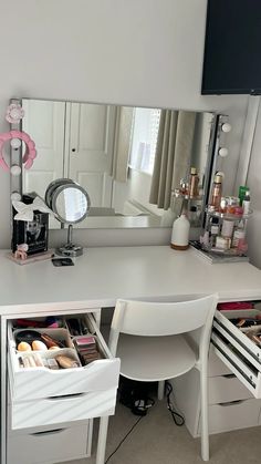 a white desk with drawers under a mirror