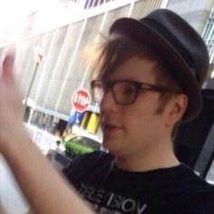 a young man wearing glasses and a hat