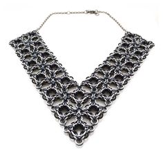 "Turn heads with this dramatic and lightweight necklace. One side is predominately silver; the other side features more black.  With the optional extender, you can wear this piece as a high collar or as a low V necklace.  Nearly 800 aluminum links were joined to create this necklace, which weighs in at a light 2 oz to keep your neck comfortable all evening long.  Each necklace is made to order and may take up to 2 weeks to ship. Choose your necklace length - the length shown is measured across t Gothic Silver Box Chain Necklace, Black Metal Chainmail Necklace, Elegant Black Chainmail Jewelry, Chainmail Patterns, Black Necklace Statement, V Necklace, Spike Earrings, Necklace Chain Lengths, Bib Necklaces