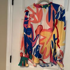 Beautiful Multicolored Top Never Worn Smock Sleeves And Pleated Neck. Length Is 25 In Fast Is 20 Inches Extra Button Enclosed Hundred Percent Polyester Single Button At Top And Back Stretch Multicolor Blouse For Spring, Trendy Multicolor Color Block Blouse, Bold Multicolor Blouse With Vibrant Print, Casual Multicolor Blouse With Abstract Print, Multicolor Stretch Long Sleeve Blouse, Trendy Multicolor Blouse With Vibrant Print, Vibrant Multicolor Blouse For Day Out, Trendy Multicolor Patterned Blouse, Multicolor Stretch Tops For Day Out