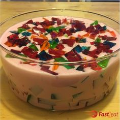 there is a cake that has been decorated with multicolored glass shards