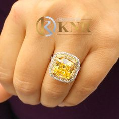 a woman's hand with a fancy yellow diamond ring on her finger and the words design for knt above it