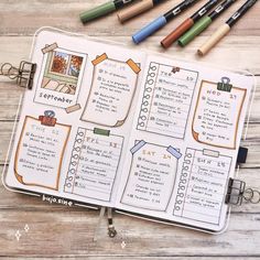 an open planner with markers and pens on it