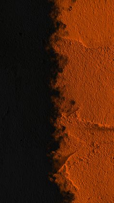 an orange and black background with some dirt