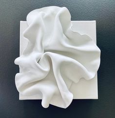 a white cloth sitting on top of a black surface