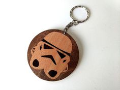 a wooden keychain with a star wars character on it