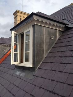 a man is working on the roof of a house