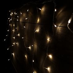 a wall covered with lights in the dark