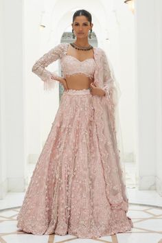 Rose pink net lehenga with a delicate 3d floral embroidery in tonal sequins, beadwork and crystals and attached cancan. Paired with an embroidered padded choli and dupatta.
Components: 3
Pattern: Embroidered
Type Of Work: Sequin, Bead, Crystal
Neckline: Sweetheart
Sleeve Type: Sleeveless
Fabric: Net, Satin
Color: Pink
Other Details: 
Attached cancan
Padded Blouse
Approx. product weight: 7 - 9 kgs
Lehenga length: 45 inches
Occasion: Wedding, Bride - Aza Fashions Pink Net Lehenga, Floral Bridal Lehenga, Pink Bridal Lehenga, Bridal Indian, Indian Bridesmaid Dresses, Designer Bridal Lehenga Choli, Reception Lehenga, Indian Bride Outfits, Pranali Rathod